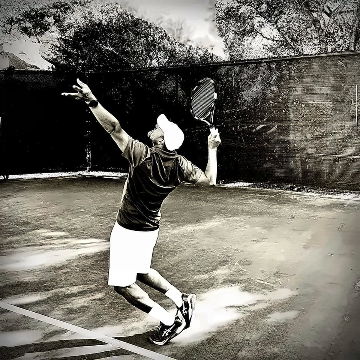 Coach Fawz serving, black and white